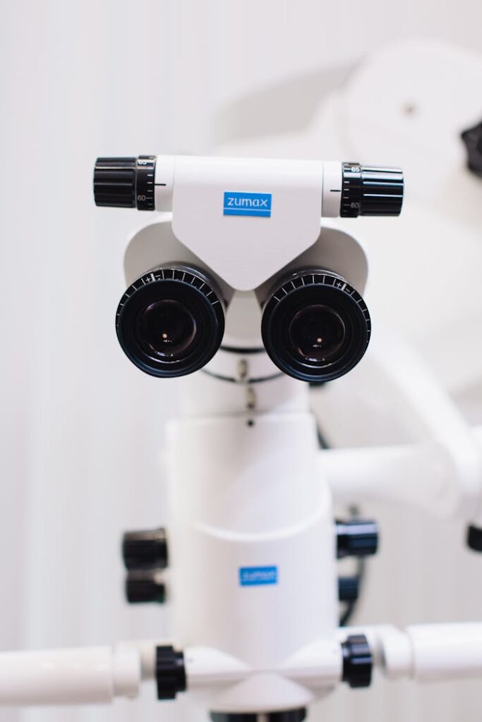 Close-up of a high-tech optical microscope used in scientific and medical fields, showcasing precision lenses and technology.