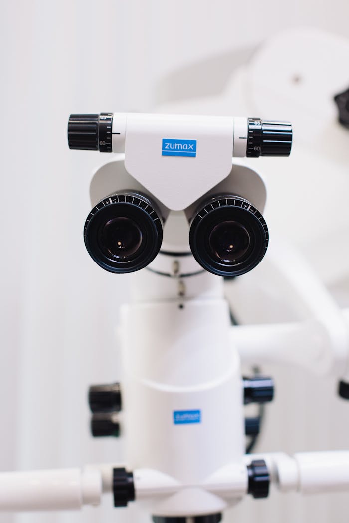 Close-up of a high-tech optical microscope used in scientific and medical fields, showcasing precision lenses and technology.